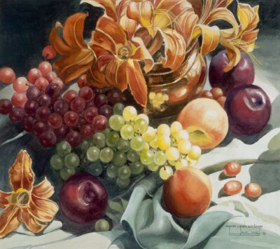 An assortment of grapes & apples under a pot of flowers